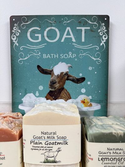 Vintage goat bath soap sign with natural goat's milk soap bars.