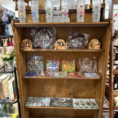 Wooden shelf displaying various decorative and gift items in a store.