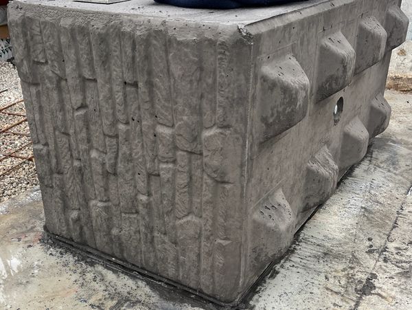 Concrete block. The front side shows the custom brick finish