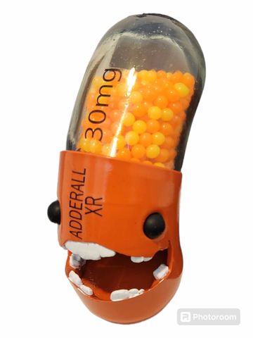 A pill capsule with a face and teeth, labeled Adderall XR 30mg.