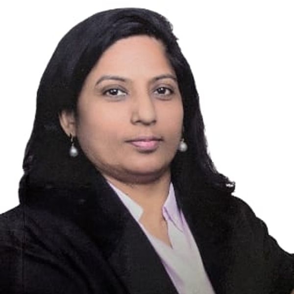 Confident woman in professional attire with crossed arms.