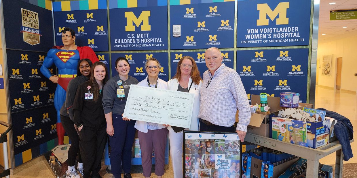 Group at University of Michigan Children's Hospital presents donation check.