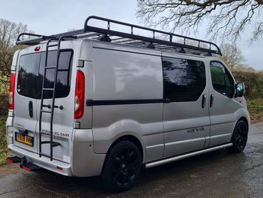 Roof rack with ladder access, sliding doors and tinted windows