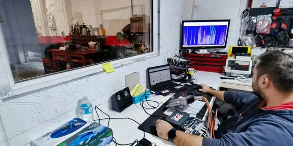 ECU diagnostics and remapping workstation in progress at TS Automotive's specialized lab.