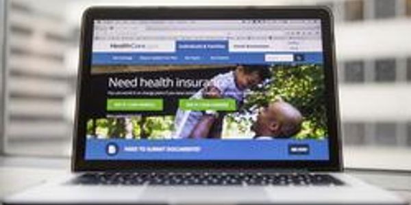 Laptop displaying a health insurance enrollment website.
