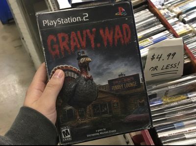 Hand holding a PlayStation 2 game titled GRAVY.WAD with a turkey on the cover.