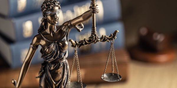 Image of lady justice holding the scales of justice - an icon for legal industries. 