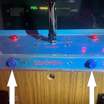 Close-up of Zaxxon arcade game controls with joystick and buttons.