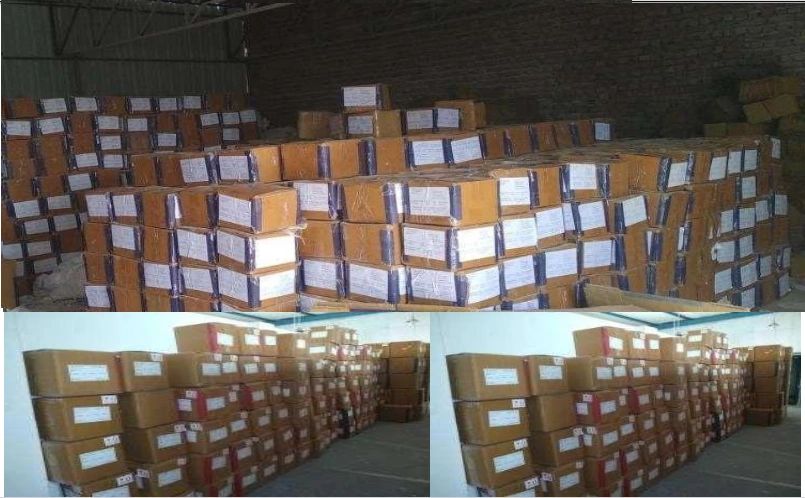 Stacks of labeled cardboard boxes stored in a warehouse.