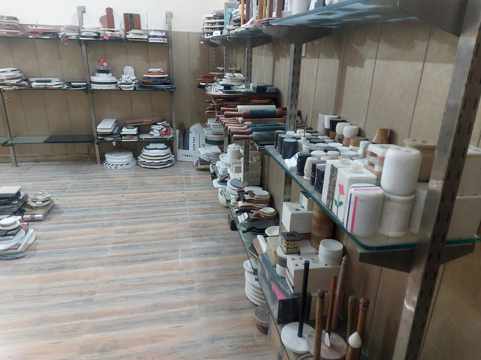 Shelves filled with various kitchenware and utensils in a store.