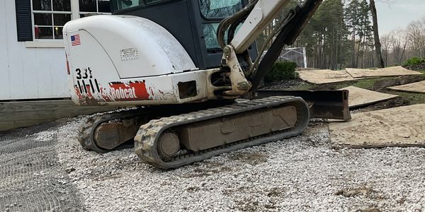 Mini excavator preparing Bass for Ohio Building Construction