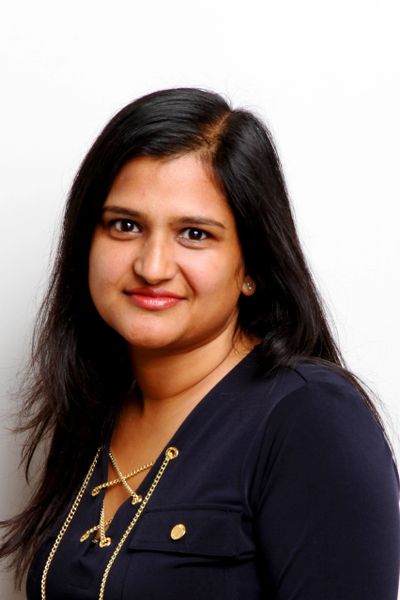 Portrait of a woman with long dark hair and a navy blue top.