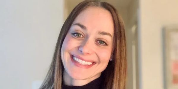 Smiling woman with straight brown hair.