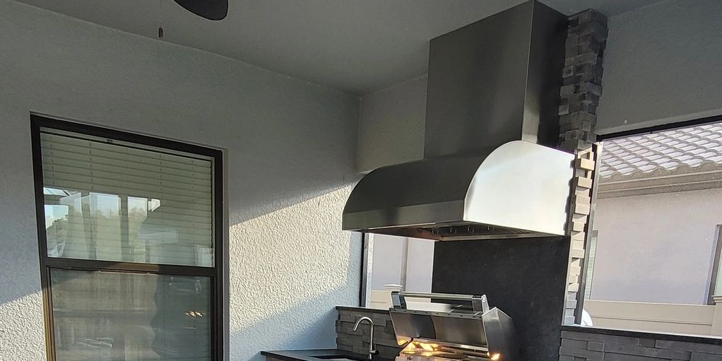 Granite backsplash with a ventilation hood for the outdoor kitchen in Tampa