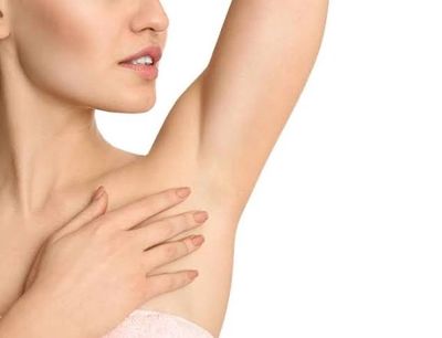 Close-up of woman's underarm and hand.