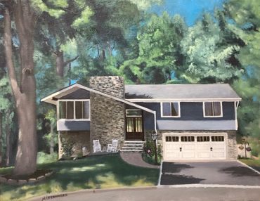 A cozy suburban house with stone and blue siding surrounded by tall trees.
