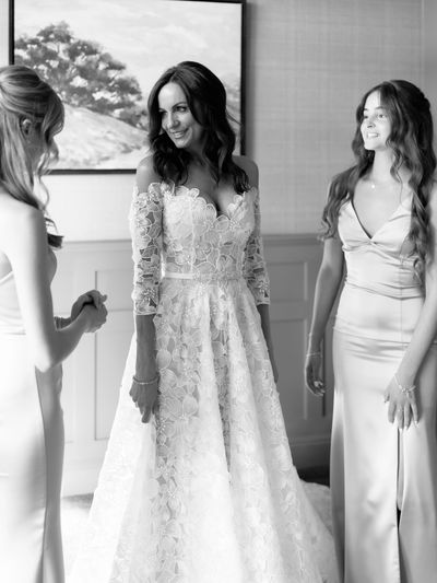 Bride in lace wedding dress with bridesmaids.