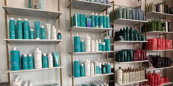 Shelves filled with various hair care products sorted by color and type.