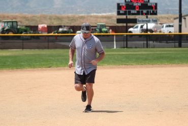 Man running on a baseball field.