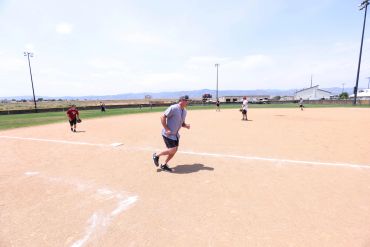 Man running on a baseball field during a game.