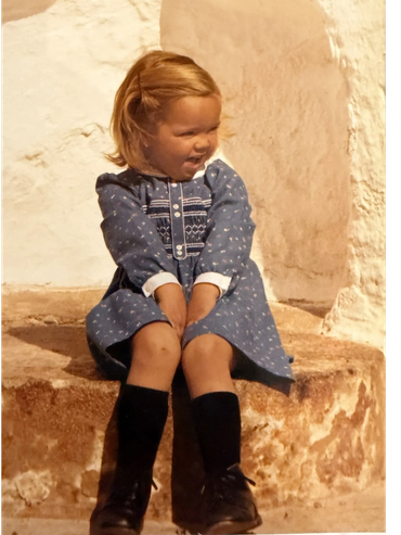 Mercedes the current owner of Cortijo Coracho and the sat on an old mill stone at the entrance to th