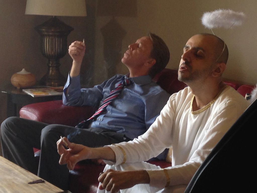 An angel and a businessman smoking.