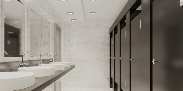 A modern public restroom by ABS with high-quality toilet compartments offers privacy and durability.