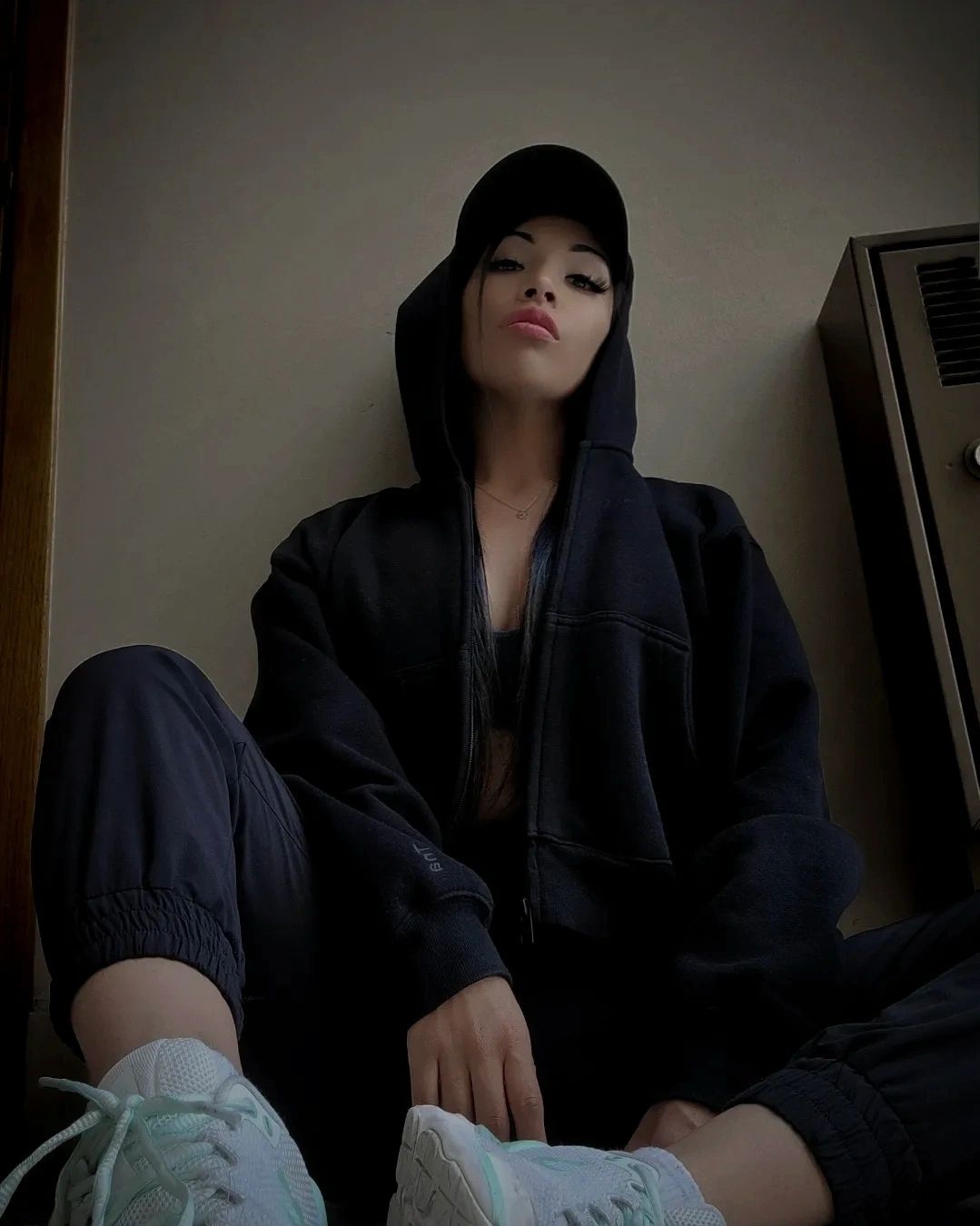 Hot indigenous Auntiez sitting on floor wearing hoodie from the show auntiez 