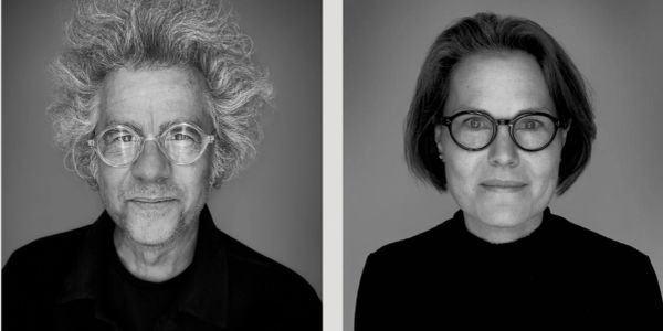 Black and white portraits of a man and a woman both wearing glasses.