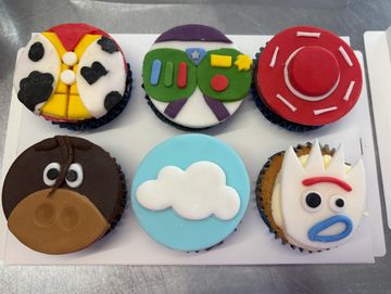 Cupcakes decorated with Toy Story character themes.