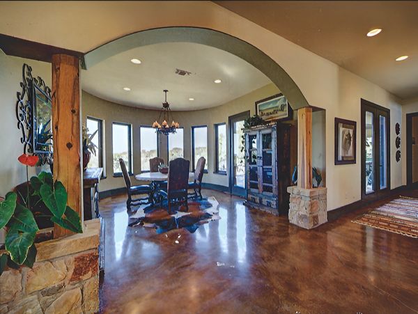 Expansive living room with a significant archway, creating a seamless flow between spaces.