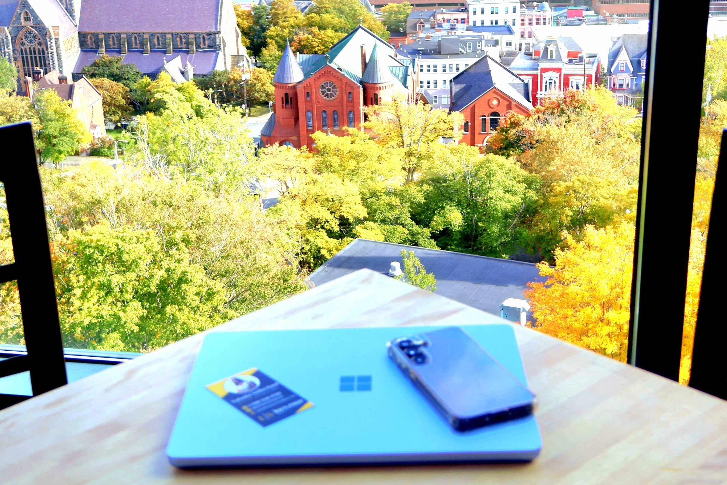Photo of a laptop and cellphone at the Rooms Cafe overlooking St. John’s 