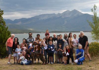 Large family gathering outdoors by lake Dillon Colorado with Peak One and the 10-mile range of mount
