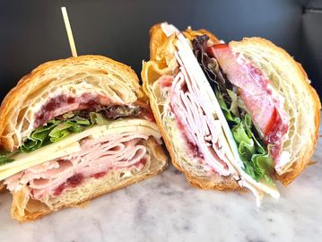 Mockingbird Sandwich -  turkey & Havarti, lettuce, tomato, cranberry sauce, croissant