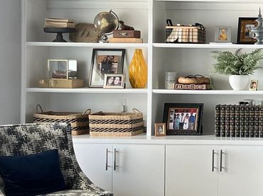 Cozy living room shelf with decorations and books.