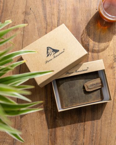 A leather wallet in a Picco Massimo box on a wooden table.