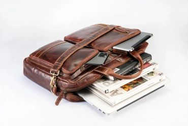 A leather briefcase packed with gadgets and documents.