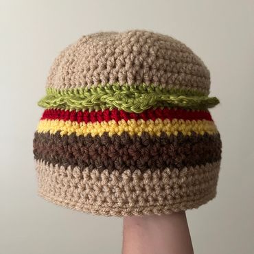 A crocheted hat resembling a hamburger.