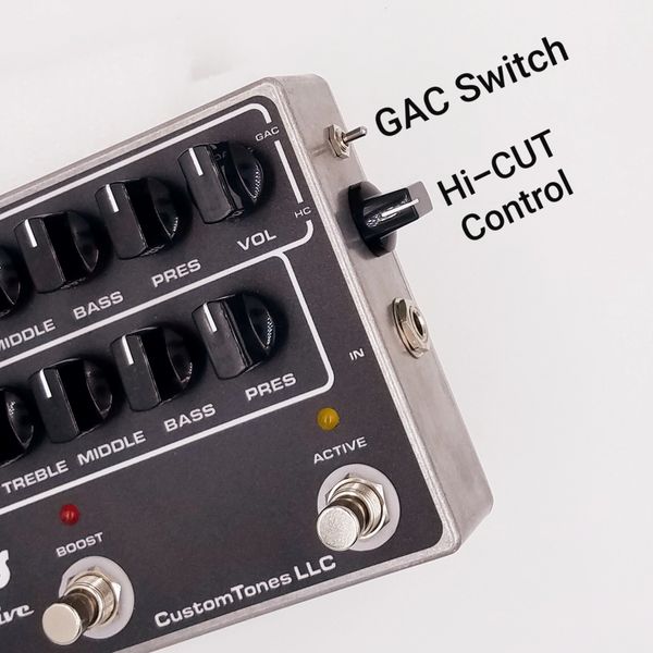 Close-up of a CustomTones LLC audio control pedal with multiple knobs and switches.