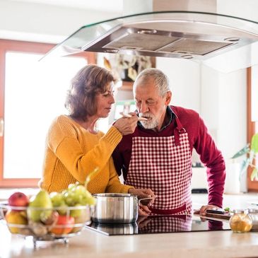 Elderly couple preparing a meal