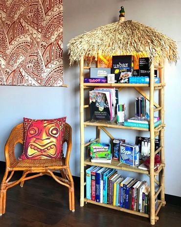 Books, board games, and adult coloring books at Tiki Tide Kava Bar in Fort Lauderdale. Kratom Bar.