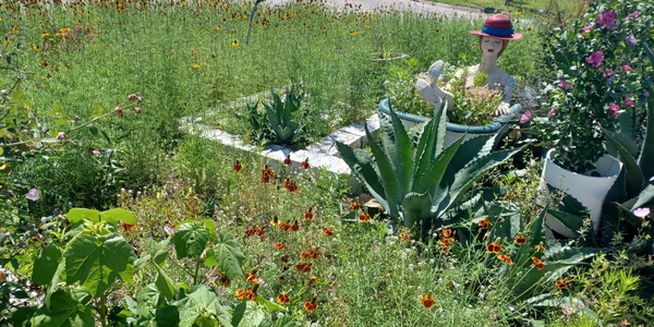 Custom flower garden with a lady in a tub mixed media art sculpture.