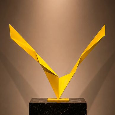 Yellow abstract sculpture with sharp wings on a pedestal.
