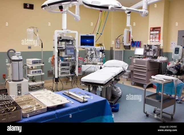 A clean and organized surgical operating room with medical equipment and an operating table.