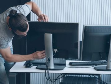 an image of someone setting up a computer for an office 