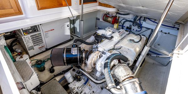 Clean and organized marine engine room with Cummins Onan generator.