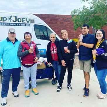 Steve and the Red Mountain High School Mountain Movers club standing in front of the truck