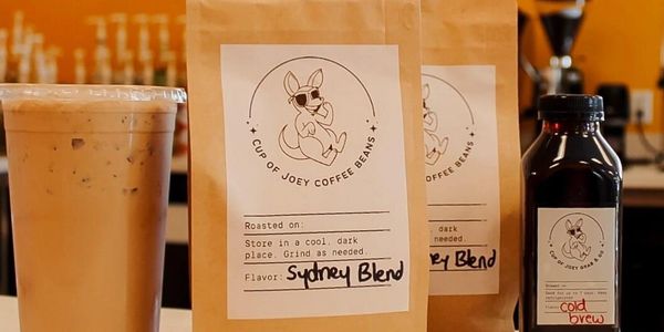 Cold brew latte, two bags of coffee beans, and a to-go bottle of cold brew. 
