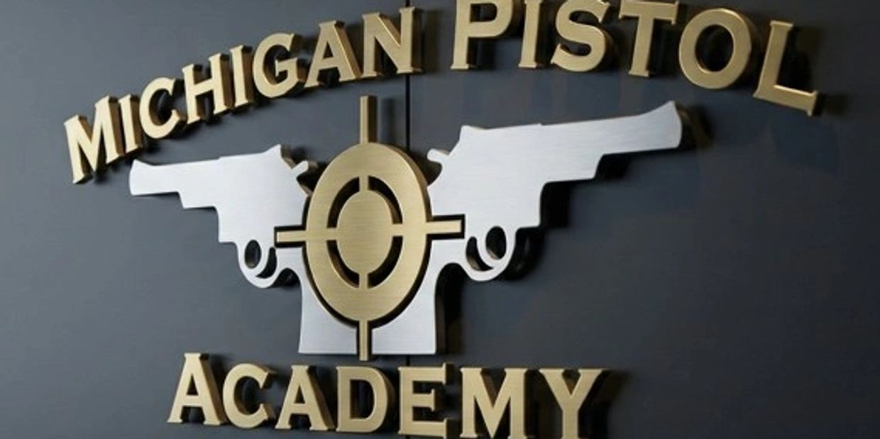 Sign for Michigan Pistol Academy with two pistols and a target.