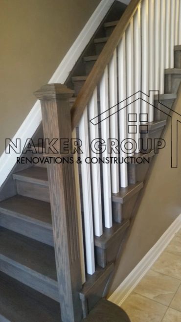 Wooden staircase with white balusters and a polished newel post.